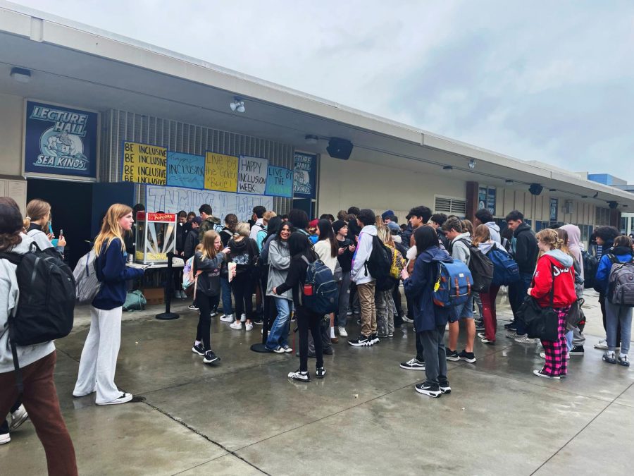 CdM students line up to get popcorn and cotton candy, while using this time to socialize. Photo courtesy of Kaydence Osgood, edited using PicsArt