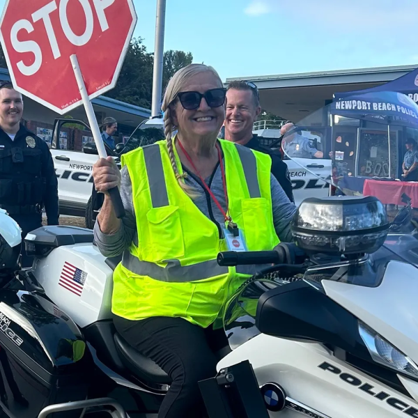 Katharine Japes posing with a stop sign on a police motorcycle.

Photo courtesy of Katharine Japes’s GoFundMe page