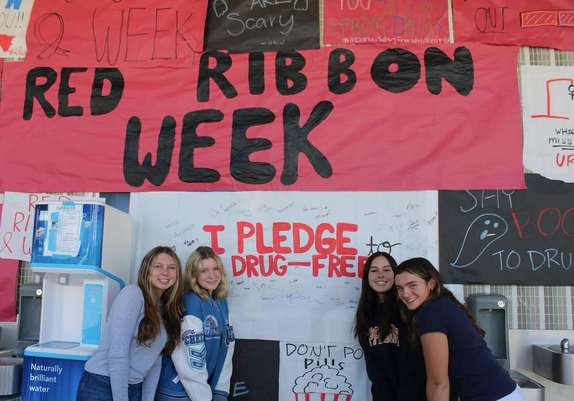 PAL members posing in front of the “Pledge Poster” Photo Courtesy of @cdmpal on Instagram