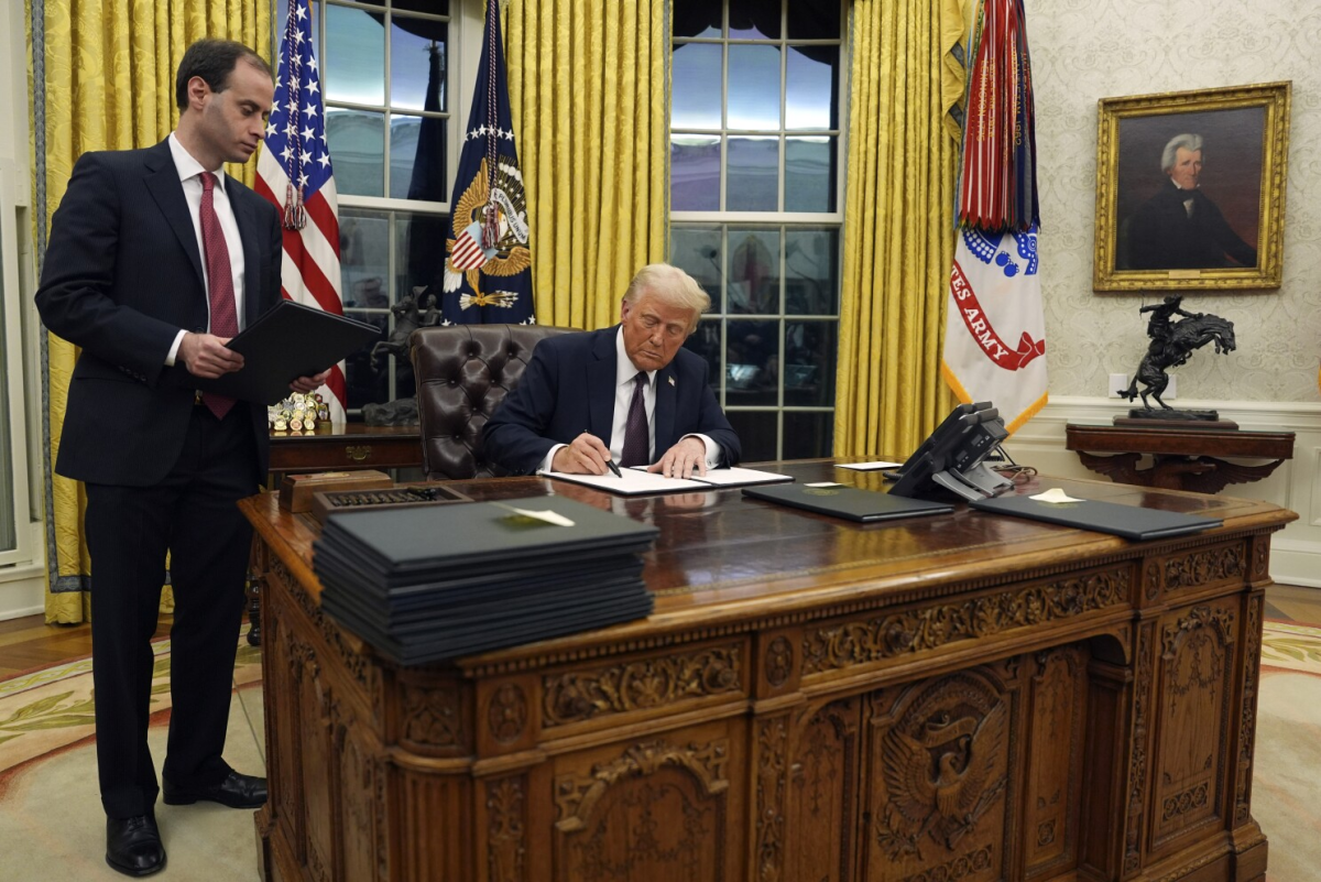 Photo courtesy of Associated Press. President Donald Trump is signing the executive order to withdraw the US from the WHO.
